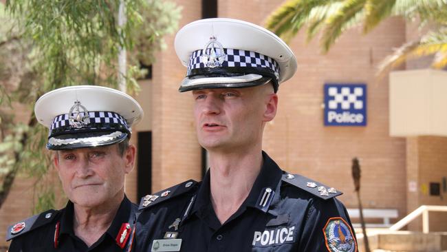 Assistant Commissioner Domestic Violence and Youth Command Michael White and Acting Commander Crime and Intelligence Command Drew Slape address media out the front of Alice Springs police station on Monday. Picture: Gera Kazakov