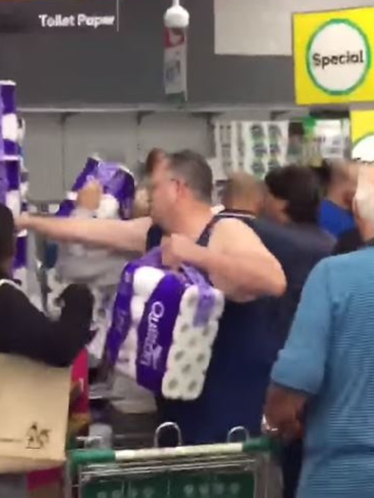 Shoppers at Woolworths Revesby in Sydney’s south-west scrambling to get their hands on toilet paper packs. Picture: Seven News