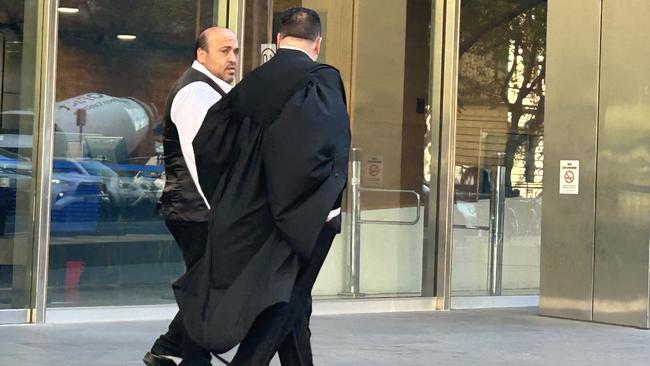 Zakaria El-Kurdi, left, leaving the County Court after being released on a good behaviour bond following his conviction for importing tobacco products without paying more than $1m in duty.