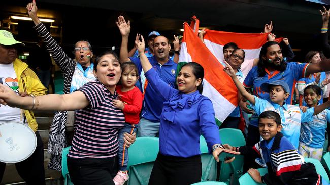 Indian fans celebrate in the rain as the T20 World Cup semi-final between England and India is washed out at the SCG on Thursday. Picture: Phil Hillyard