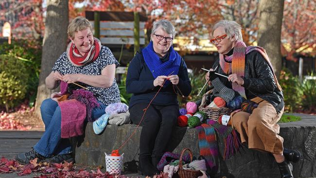 Di Liebelt, Uraidla CWA, Linda Terrel, Mt Barker CWA, and Julie Kimber, Stirling CWA, knitting gifts to be sold for charity. Pictured outside Fleurs at Stirling. Picture: Tom Huntley