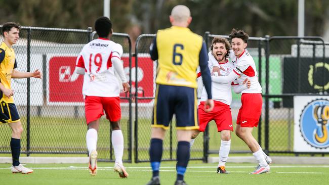 Croydon Kings players celebrate with Patrick Caraccia after he scored during their NPL SA win over Modbury Jets on Saturday. Picture: Adam Butler