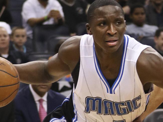 Orlando Magic guard Victor Oladipo (5) drives past New Orleans Pelicans guard Eric Gordon (10) during the first half of an NBA basketball game in Orlando, Fla., Friday, Feb. 20, 2015. (AP Photo/Reinhold Matay)