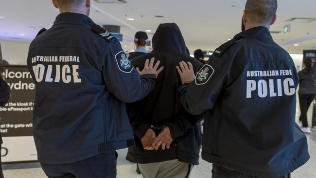 Guy Habkouk pictured with federal police following his extradition from Turkey to Australia in 2023. Picture: AFP