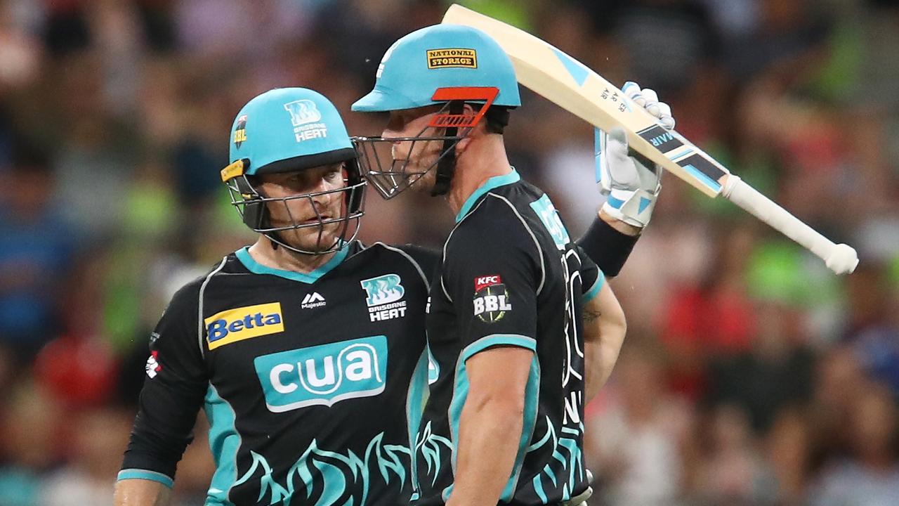 Brendon McCullum raises his bat after scoring 50 for the Heat against the Thunder.