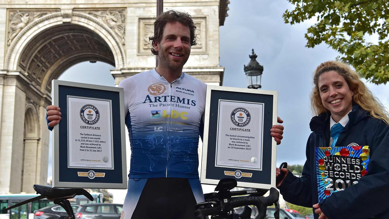Scottish cyclist Mark Beaumont with his Guinness World Records certificates after arriving at the Arc de Triomphe in Paris. Picture: Christophe Archambault