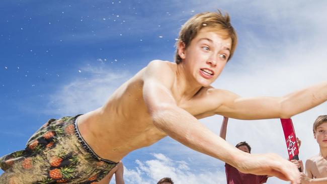 Archie Gouldson (catching the ball) was pictured on the front page of The Courier-Mail in 2017. Photo Lachie Millard