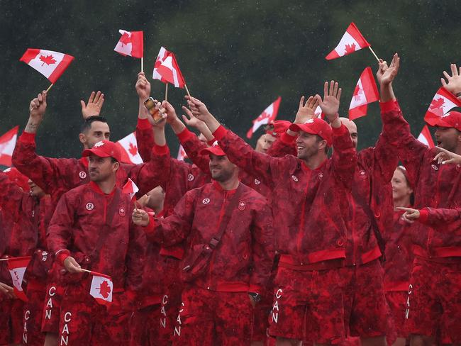 Team Canada athletes wave their flags on the team boat along the River Seine. Picture: AFP