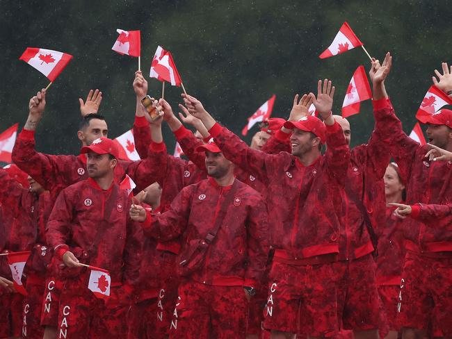 Team Canada athletes wave their flags on the team boat along the River Seine. Picture: AFP