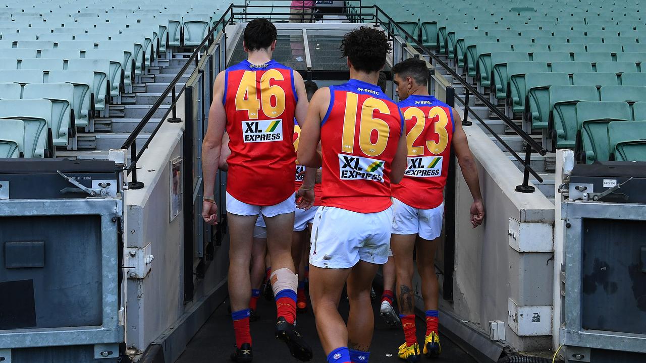 The Lions walk off the MCG after Sunday’s loss to Hawthorn.