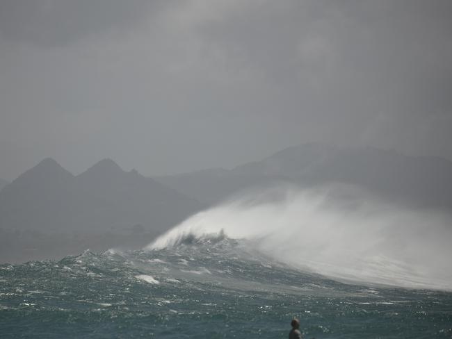 Waves whip up around The Pass at Byron Bay. Picture: NewsWire / Glenn Campbell