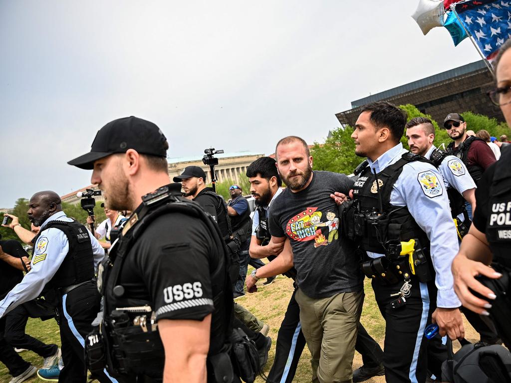 A demonstrator wearing a shirt that reads “Eat the Rich” is arrested during a protest in Washington, DC. Picture: AFP