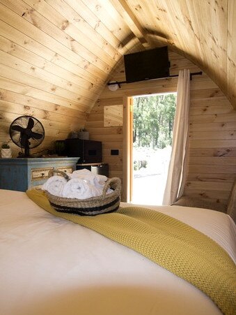 The pods have a small kitchenette and sofa, as well as the bed. Picture: Supplied/Glampinghub.com