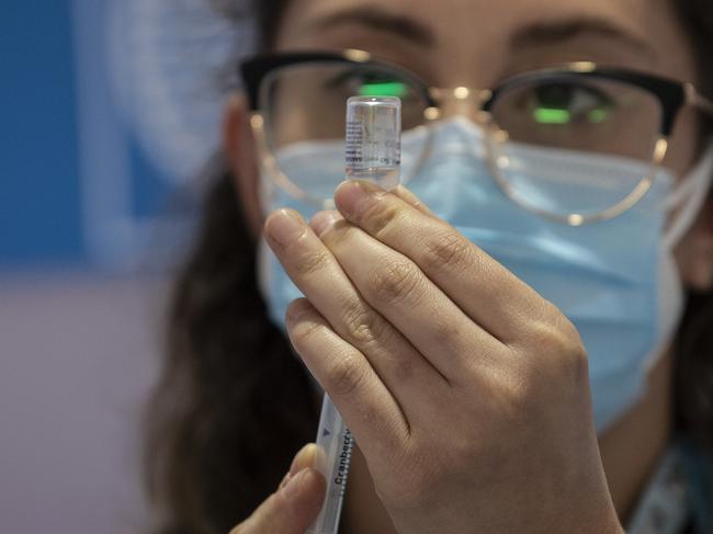 A health worker prepares a Pfizer vaccine in Brazil. The country has approved use of the jab in children 12 and up. Picture: Getty Images