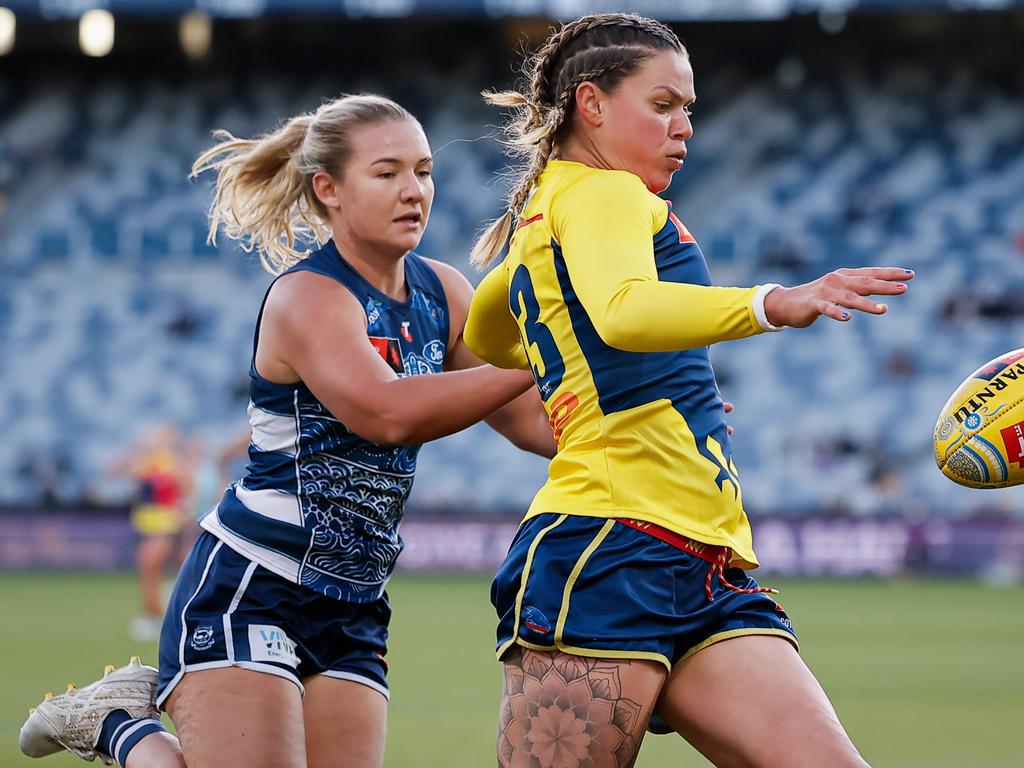 Anne Hatchard gets a kick away for the Crows.