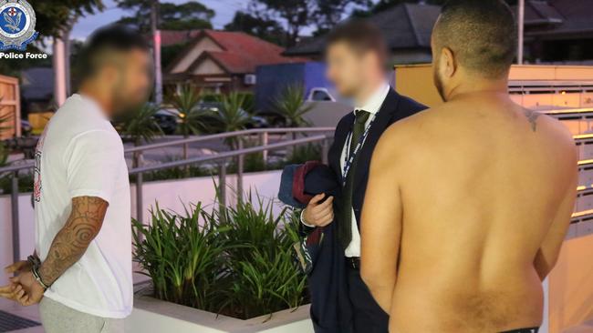 A detective speaks to two men arrested last week in relation to an alleged 'dial-a-dealer' drug syndicate in northwest Sydney. Picture: NSW Police