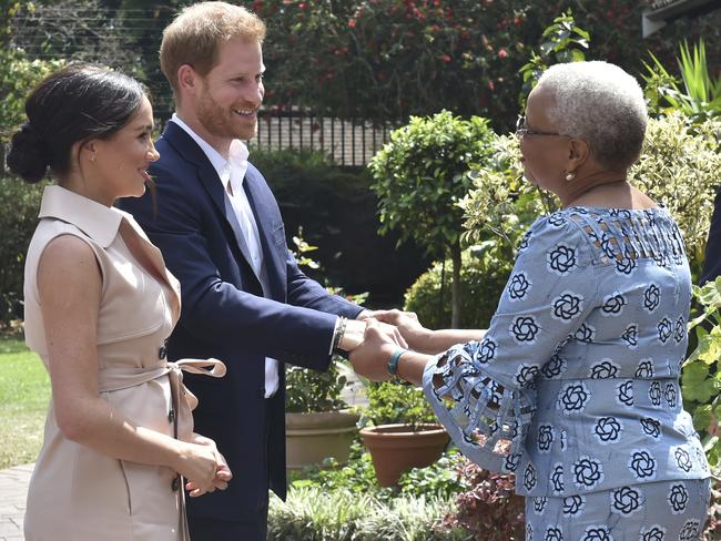 Britain's Prince Harry and his wife Meghan, Duchess of Sussex, meet with Graca Machel, the widow of the late Nelson Mandela, in Johannesburg. Picture: AP