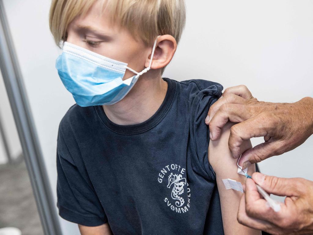 A 10 year old, receives a vaccination against coronavirus in Amagar, Denmark is ending its nationwide campaign. Picture: AFP / Denmark OUT