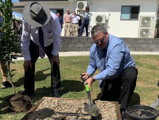 Dawson MP Andrew Willcox got to work to help Robert MacKenzie plant a mandarin tree in the backyard. Picture: Duncan Evans