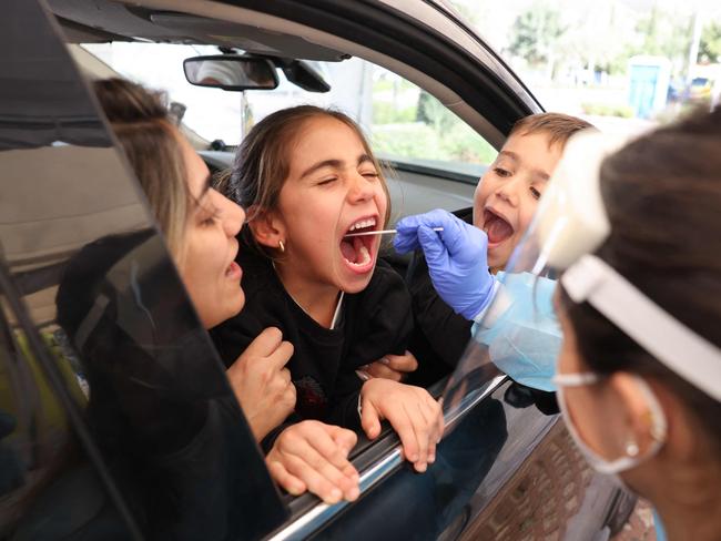 An Israeli paramedic collects a swab sample from a child at a coronavirus testing centre in Jerusalem. Picture: AFP