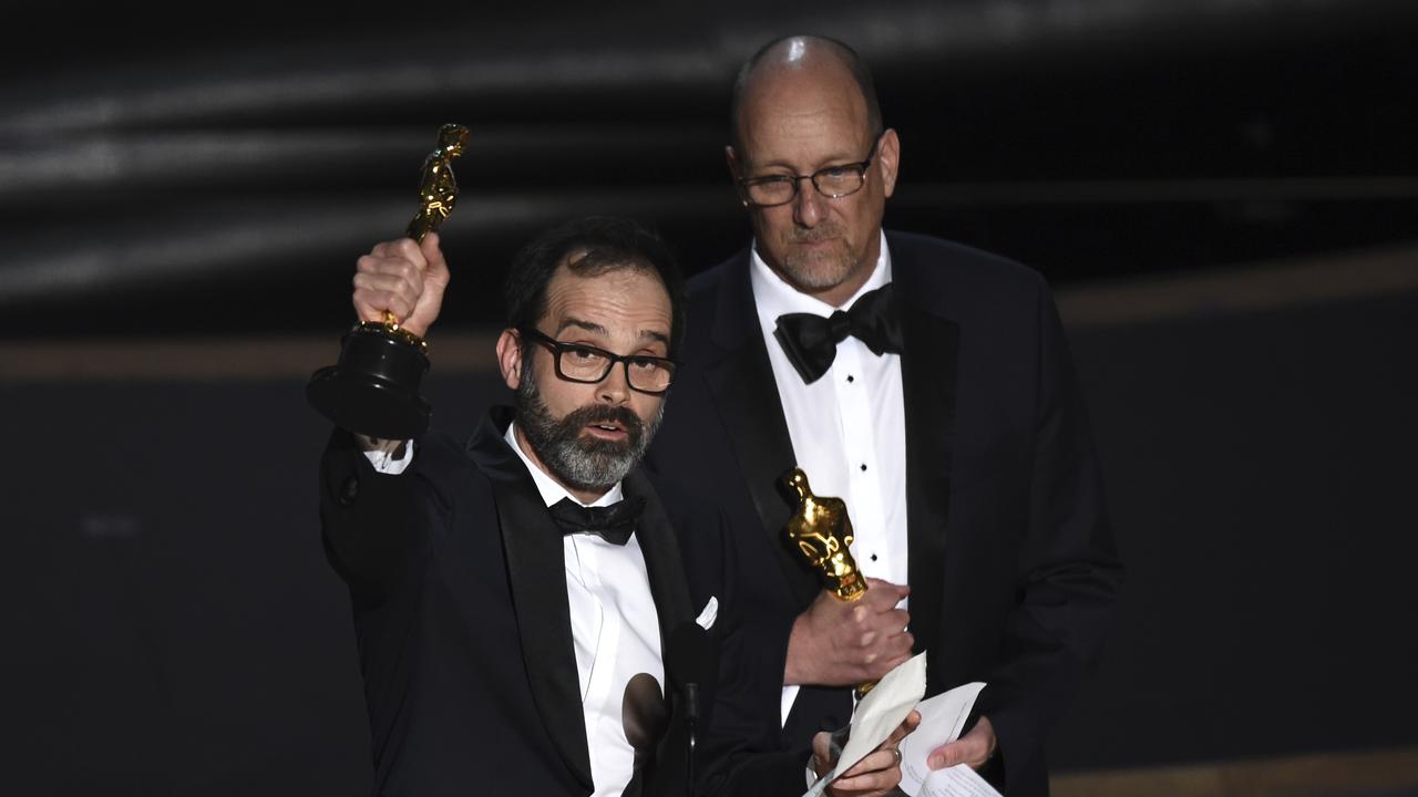 Best Film Editing: <i>Ford v Ferrari</i>. Andrew Buckland, left, and Michael McCusker, right, accept the award. Picture: AP