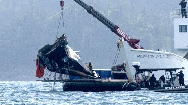 A barge anchored at the site where a MRH 90 military helicopter crashed, lifts out the tail section. in the Whitsundays while carrying four Australians -Saturday 29 July 2023 Picture: Michaela Harlow