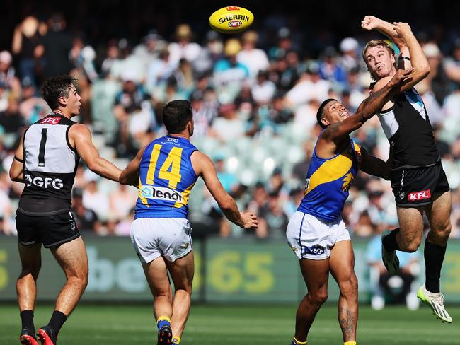 Jason Horne-Francis fires out a handpass against the Eagles in round 1. Picture: James Elsby/AFL Photos