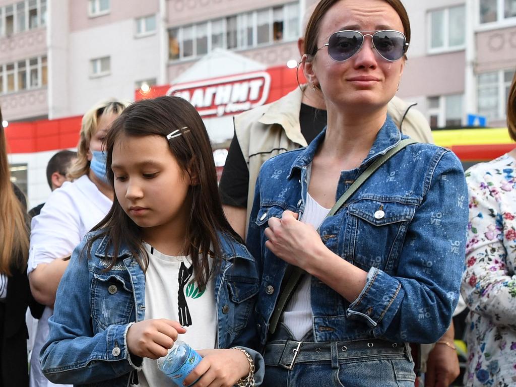 A woman wells up at a makeshift memorial for victims of the shooting at School No. 175 in Kazan on May 11. Picture: Natalia Kolesnikova / AFP