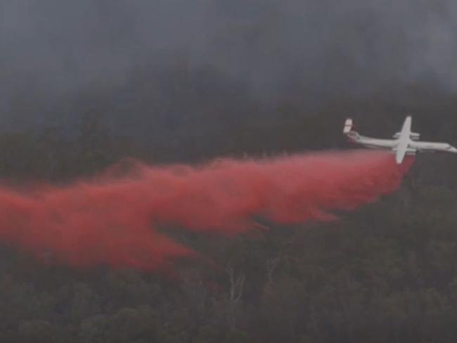 Queensland's new aerial water bomber drops retardant on the bushfire in the Scenic Rim. Picture: QFES