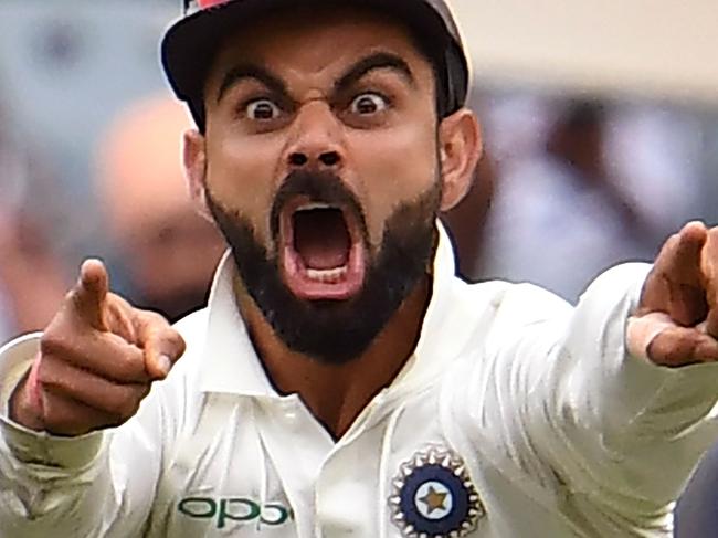 India's captain Virat Kohli celebrates the wicket of Australia's Pat Cummins on the final day of the third cricket Test match between Australia and India in Melbourne on December 30, 2018. (Photo by WILLIAM WEST / AFP) / -- IMAGE RESTRICTED TO EDITORIAL USE - STRICTLY NO COMMERCIAL USE --