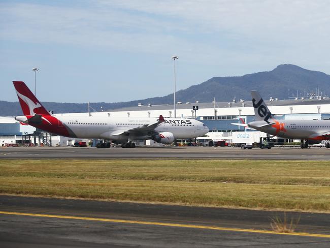 A Qantas Airbus A330 and a Jetstar Airbus A320 wide body passenger jet aircraft sit on the tarmac at the Cairns Airport international terminal. The large passenger planes have begun to fly internationally for the first time since the Covid-19 coronavirus pandemic halted international air travel worldwide, with limited direct flights from Cairns to Auckland in New Zealand. Picture: Brendan Radke