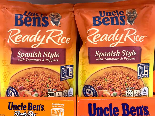 (FILES) In this file photo taken on June 17, 2020 Bags of Uncle Ben's rice are seen on a store shelf in Washington,DC. - Amid nationwide protests against racism, major US food companies on June 17, 2020 said they would change the Aunt Jemima and Uncle Ben's brands, both of which feature African American mascots. The United States has a long history of racist caricatures of African Americans and other minorities across popular culture, though in recent decades those images have become increasingly taboo.Businesses across the world's largest economy are facing a reckoning over branding following last month's killing of a black man, George Floyd, at the hands of police in Minneapolis, which sparking many protests against racism. (Photo by Eva HAMBACH / AFP)