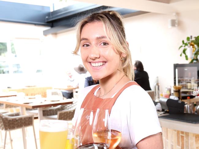 Ivy Thomas Waitress and Tom Higgins (behind)Waiter, are both wait temp staff there are Labour shortages due to covid, in Melrose Bulimba, on Sunday 3rd July 2022 - Photo Steve Pohlner