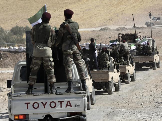 Turkey-backed FSA fighters are heading toward Syrian town of Tal Abyad from Turkish border town of Akcakale, Turkey. Picture: AP