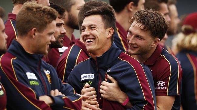 Hugh McCluggage, middle, is hugged by team-mate Alex Witherden.