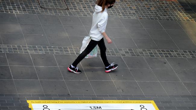 Regional areas are in for relief, but the lockdown continues in Melbourne, where the District Docklands shopping precinct is deserted apart from the odd passer-by. Picture: NCA NewsWire/Andrew Henshaw