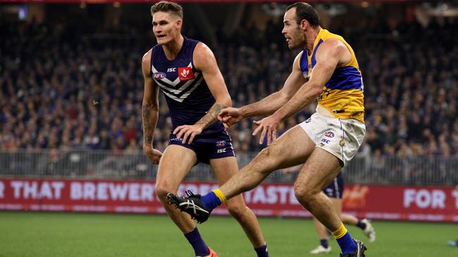 Shannon Hurn of the Eagles kicks the ball during the Round 16 match between the Dockers and the Eagles at Optus Stadium. Picture: AAP Image/Richard Wainwright