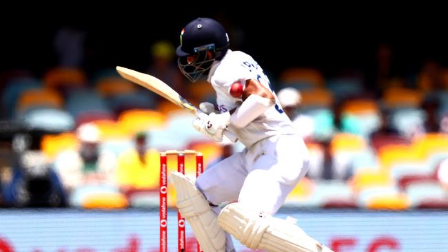 Pujara is drilled in the shoulder by a Pat Cummins bouncer. Picture: AFP