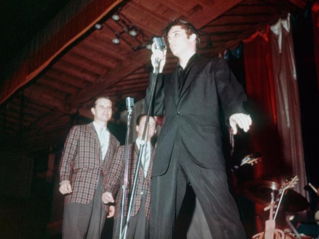 Elvis Presley preforms on stage with his back up singers "The Jordanaires" in 1955. Picture: Michael Ochs Archives/Getty Images