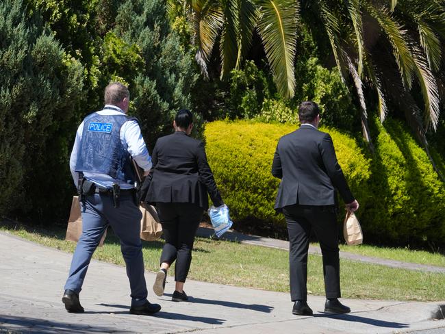 Police are investigating an incident at Gulfview Heights where two people were stabbed. Police collecting evidence at the property, including removing a machete from the rear of the house. 9 October 2024. Picture Dean Martin