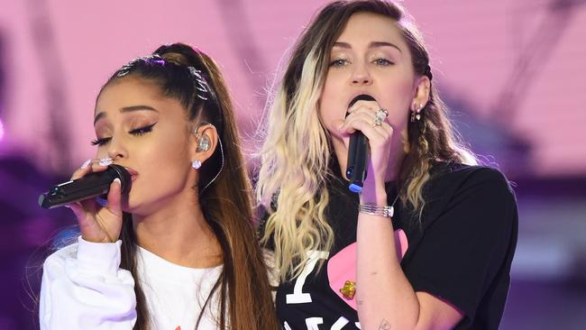 MANCHESTER, ENGLAND - JUNE 04:  NO SALES, free for editorial use. In this handout provided by 'One Love Manchester' benefit concert (L) Ariana Grande and Miley Cyrus perform on stage on June 4, 2017 in Manchester, England. Donate at www.redcross.org.uk/love  (Photo by Getty Images/Dave Hogan for One Love Manchester)