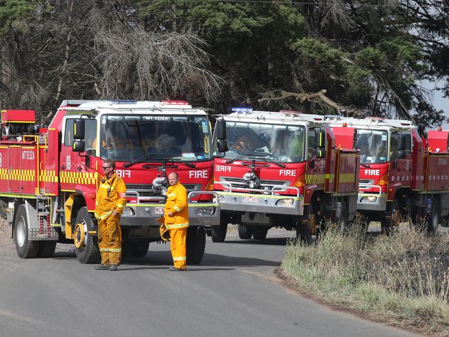 Firefighters gather on a road near Cobden in Victoria.