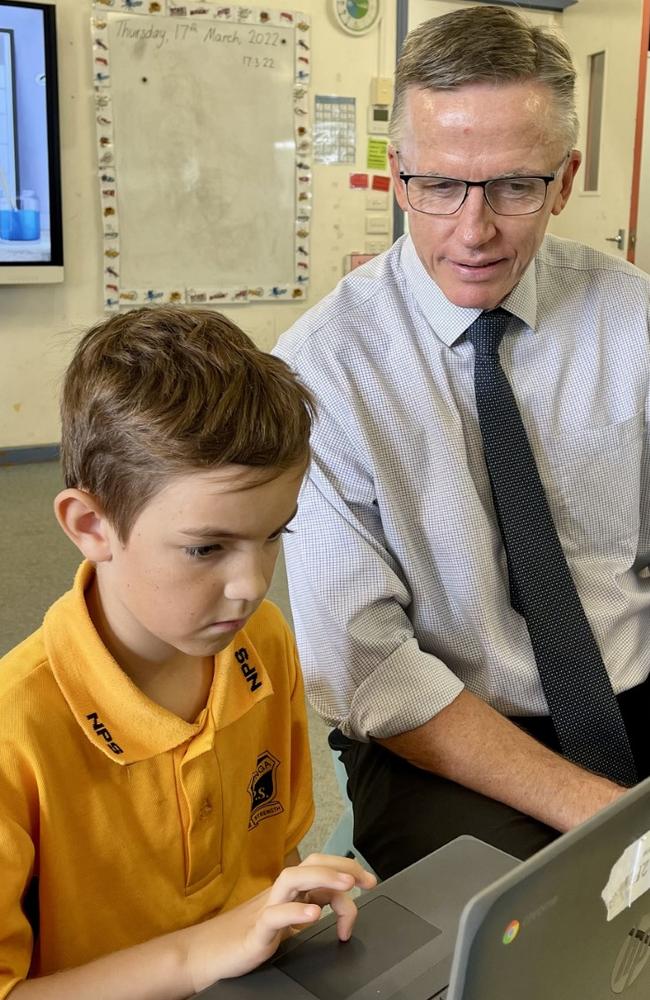 Narranga Public School principal Michael Trist helps Year 2 student Joey Johnston.