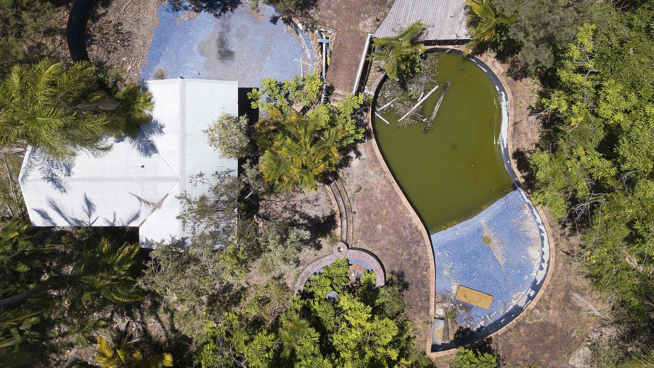 An aerial view of the swimming pools, one filled with rainwater, debris and even a mattress, at the old Great Keppel Island resort.