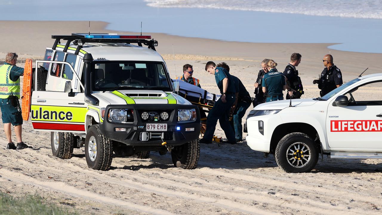 Police and ambulance officers at The Spit, Main Beach where three people were rescued from the water. Picture: Nigel Hallett