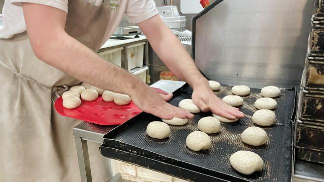 Baker Dan Moore forms the dough into small rolls after they have been well kneaded.