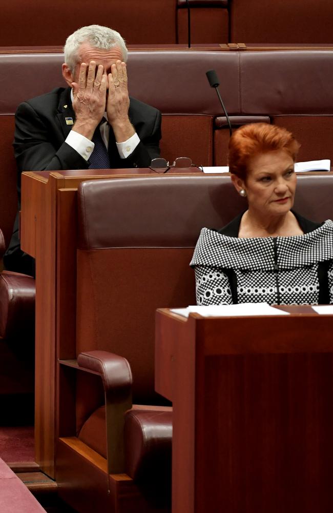 Senate says No: Senator Malcolm Roberts rubs his eyes as he and Senator Pauline Hanson (R) listen to debate around her request for the Senate to support a vote on immigration numbers. Picture: Getty