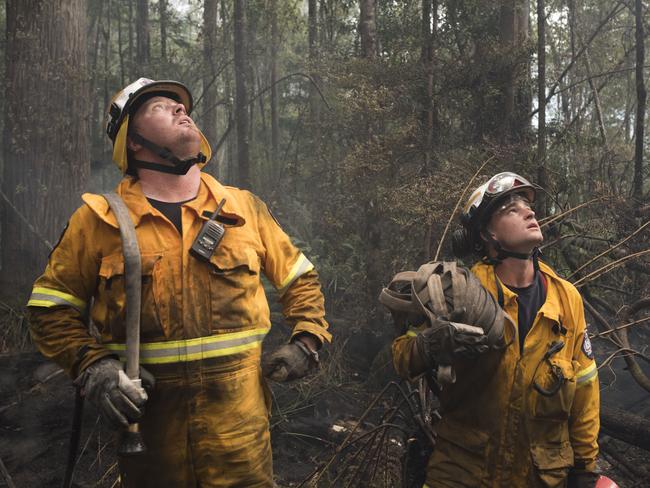 Kingston volunteer Stuart Conway and Huonville volunteer Tom Andrews take a break after halting the firein the Tahune area. Picture: WARREN FREY/TFS