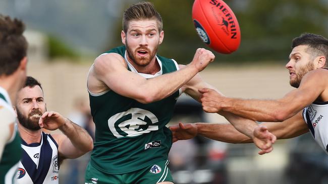 Zac McCubbin fires off a handball for Greensborough. Picture: Rob Leeson