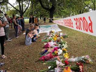 Flowers and messages of respect are placed in Hagley Park across from the mass shooting scene at the Masjid Al Noor, Christchurch, New Zealand, Saturday March 16, 2019. Picture: MARTIN HUNTER